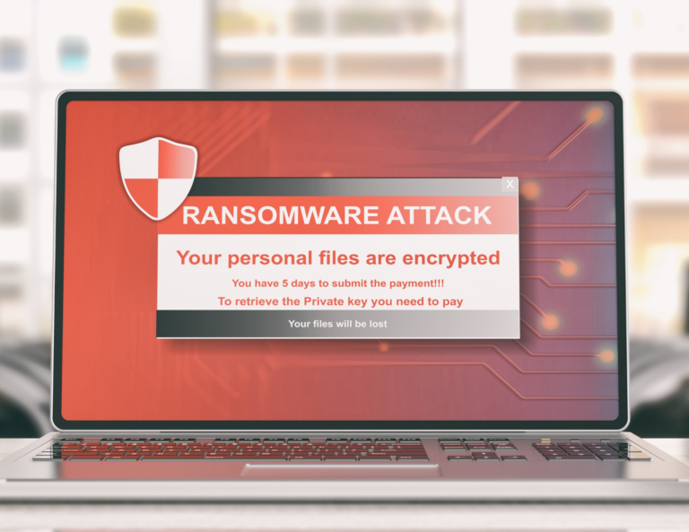 laptop open with a ransomware notice on the screen