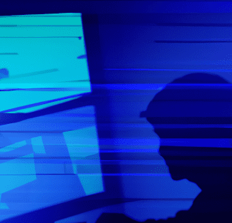 This is an image of a person watching a computer.